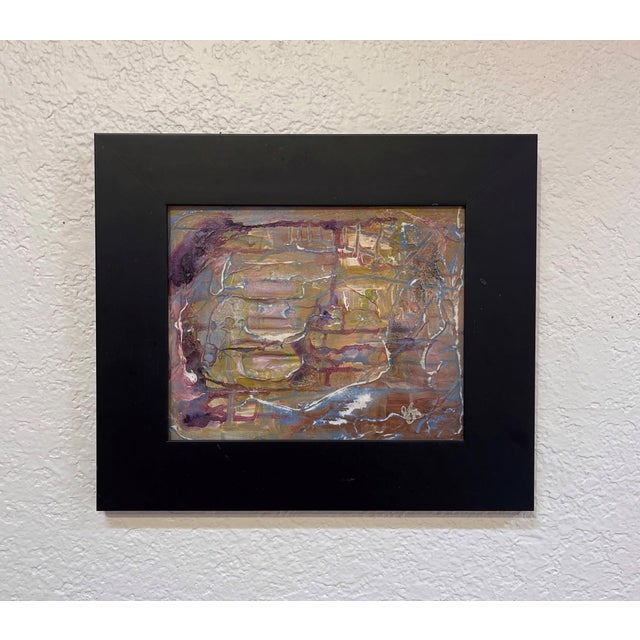 This mixed media artwork presents an abstract landscape, where layers of earthy tones intertwine with hints of vibrant...