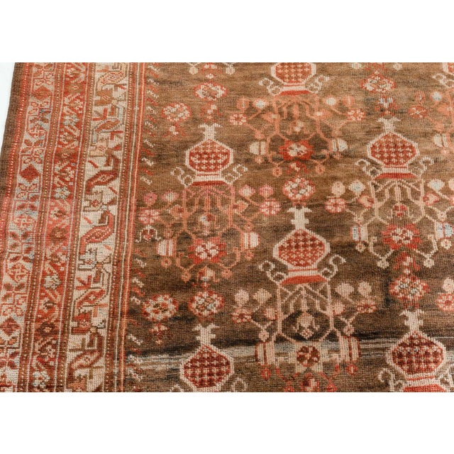 With its lovingly time-worn composition and effortless beauty, this hand-knotted wool antique Persian Malayer rug dating...