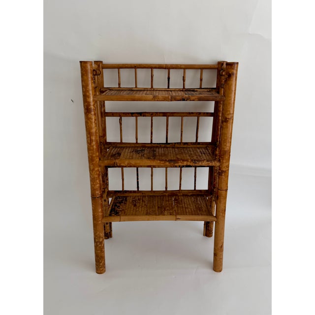 This vintage tortoiseshell bamboo 3-tier etegere is perfect for displaying decorative items, books, or towels in the bath....