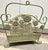 Sage green wrought-iron basket with a decorative cut out floral & basket design with a top carry handle. Handle moves....