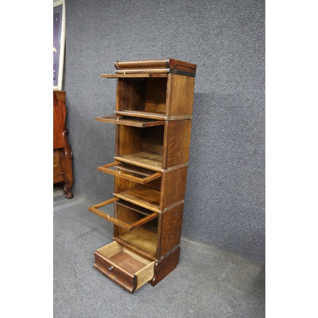 Rare early 20th-century quarter sawn oak stacking bookcase attributed to Globe-Wernicke. The bookcase features four glazed...