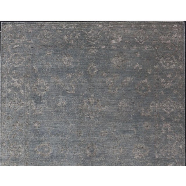 This modern Indian rug has been hand-knotted in wool and features an all-over, sub-geometric floral design rendered in...