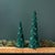 Transform your holiday home with the Green Beaded Leaf Pine Tree Set. This elegant pair of tabletop trees, featuring two...