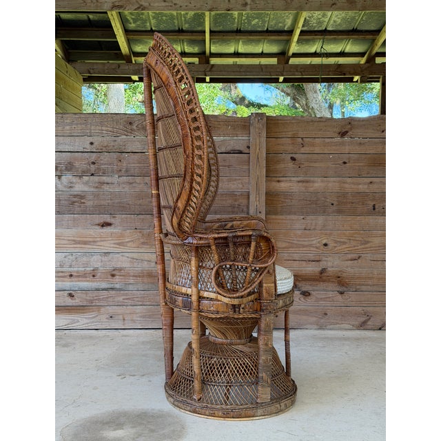 An impressive monumental vintage wicker and rattan Emmanuelle peacock chair featuring an oversized fan-shaped backrest,...