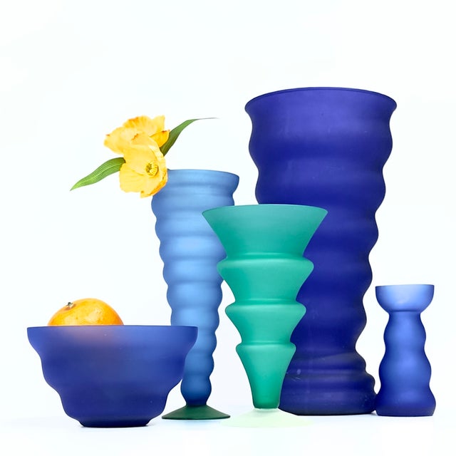 This striking collection features 1980s postmodern frosted colored glass vessels in the iconic Memphis design style,...