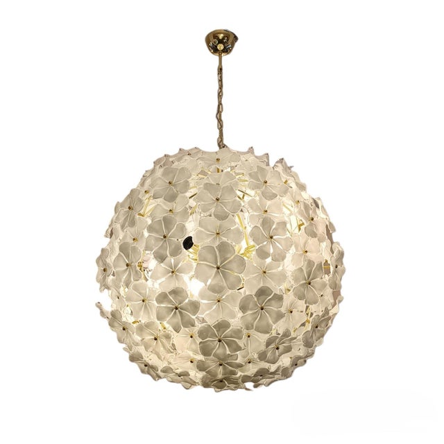 Circular ceiling lamp composed of a cluster of white Murano glass flowers with transparent edges. Each Murano glass flower...