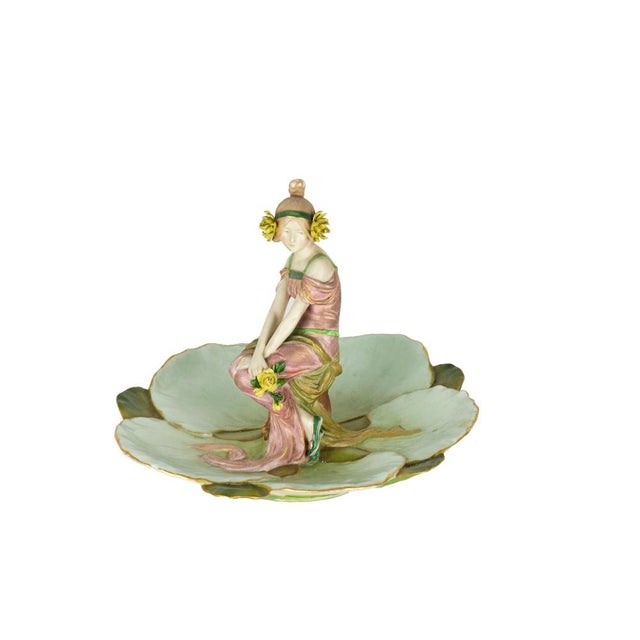 An extraordinary Secession Style Ernst Wahliss hand-painted porcelain figurine tray with an elegant seated maiden flanked...