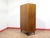 This stunning mid century walnut armoire by renowned British furniture maker Alfred Cox showcases beautiful wood grain and...