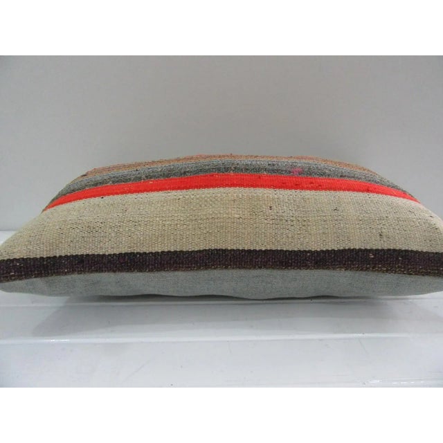 This is a pillow cover made from a vintage kilim rug. The piece was properly washed and ready to use. Pillow inserts not...