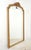 Antique French made Louis XVI style mirror with an arched crest and ribbon motif. The frame with fluted molding has a gold...
