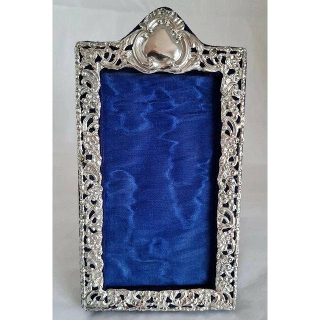 A fine edwardian photograph frame dating to 1904, featuring a beautifully decorated sterling silver mount by **h. V....