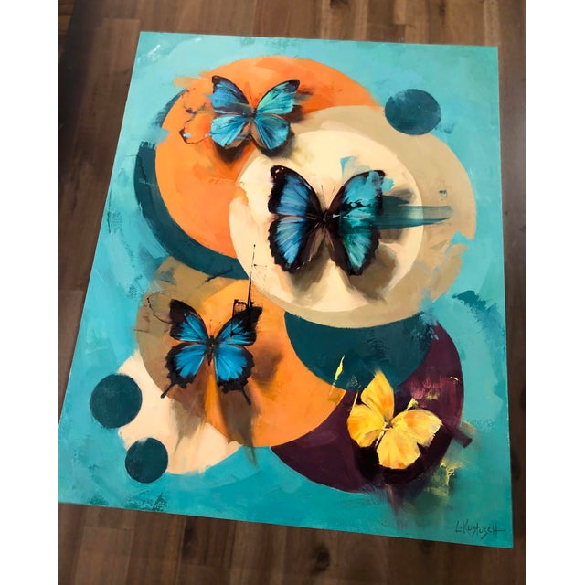 Kaleidoscope #2 features a vibrant composition of butterflies set against a backdrop of circular forms in soothing...