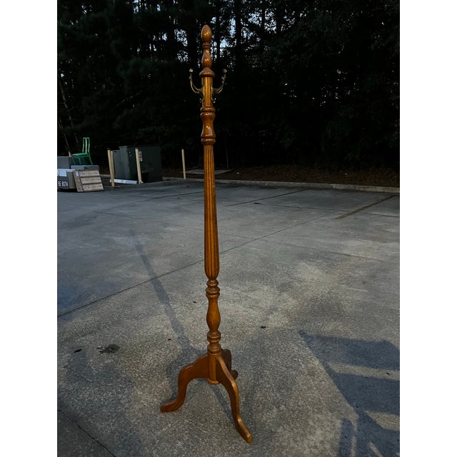 Up for consideration is a beautiful vintage tall wooden coat rack with brass hooks. This would look lovely in your home,...