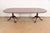 An exceptional Georgian or Chippendale style double pedestal extension dining table In the manner of Baker Furniture USA,...