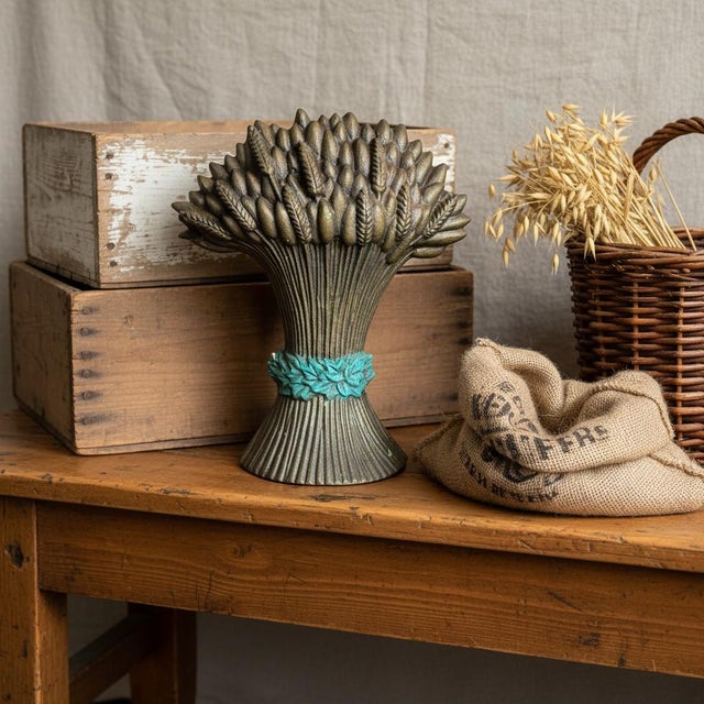 Celebrate the harvest season year-round with this vintage cast iron wheat sheaf doorstop featuring a rich antiqued gold...