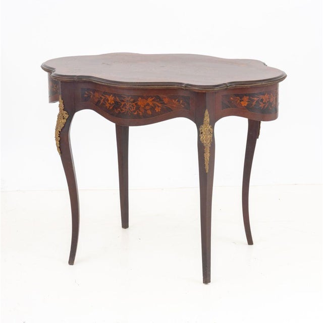 Louis XV Style Gilt Metal Mounted Kingwood and Marquetry Scalloped Shaped Center Table, late 19th century. 28.5" H x 37" W...