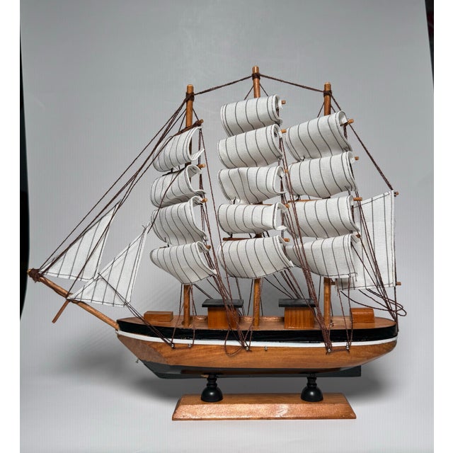 This is a decorative wooden model of a multi-masted “tall ship”—specifically styled after a 19th-century American clipper...