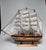 This is a decorative wooden model of a multi-masted “tall ship”—specifically styled after a 19th-century American clipper...