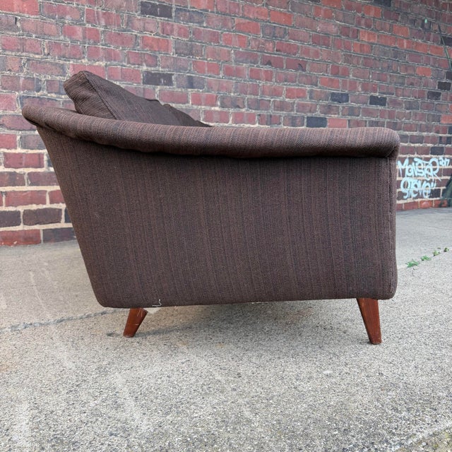A beautiful design by Swedish designer Folke Ohlsson, this upholstered three seat sofa with gently curved lines is...
