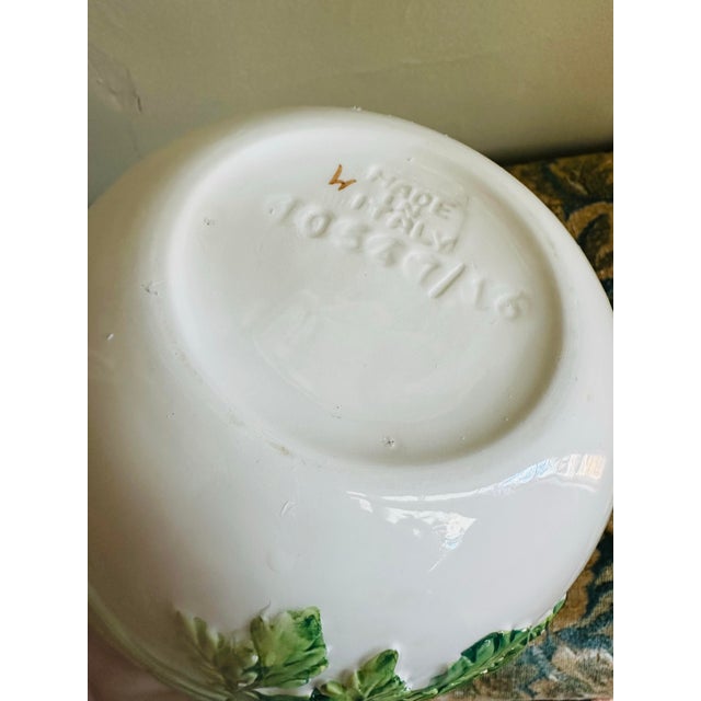 A sculptural Italian majolica bowl featuring high-relief celery leaves wrapped around the exterior in rich shades of hand-...