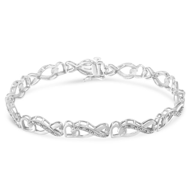 Elegant and timeless, this gorgeous sterling silver link bracelet features 0.2 carat total weight of round diamonds with a...