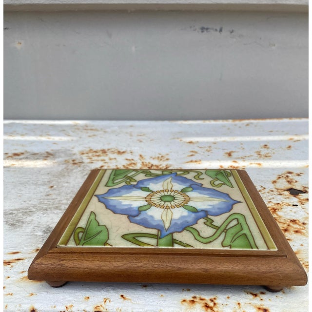 Art Nouveau Majolica trivet in a footed wood frame, circa 1900. Purple flower passion flower or passiflora. 7.5" by 7.5"