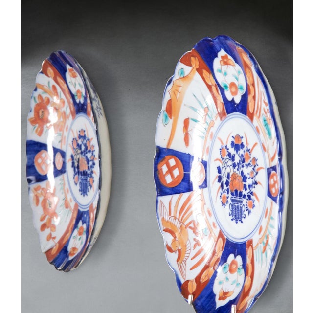 A colourful set of six late 19th century imari plates. with shaped edge and repeating opposing patterns with central...