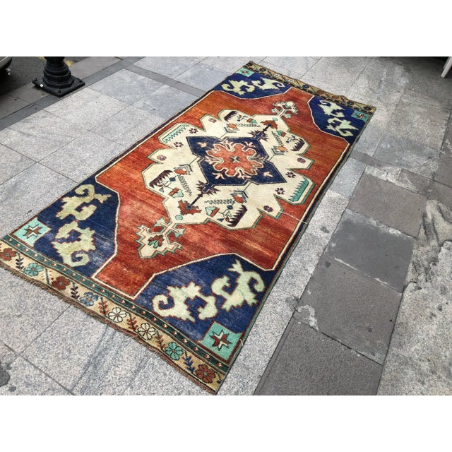 This is a vintage Turkish Oushak rug from the 1960s. The piece was hand-knotted.