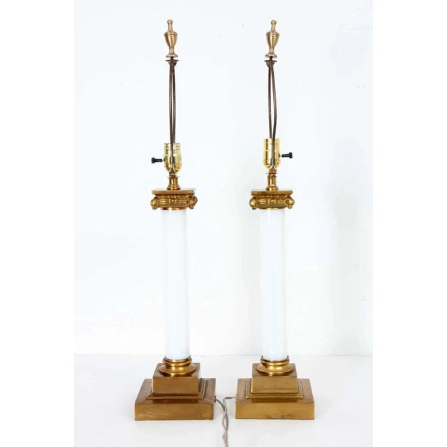 Pair of elegant Neoclassic style Paul Hanson 1950's-1960s columnar-form glass lamps. Each lamp features cased glass column...