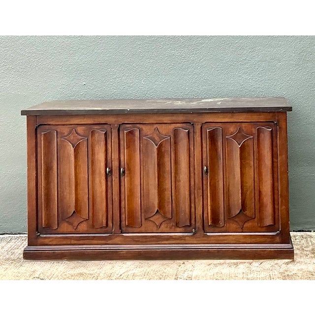 This vintage carved walnut credenza pairs mid-century craftsmanship with a striking slate top. The case is built from...