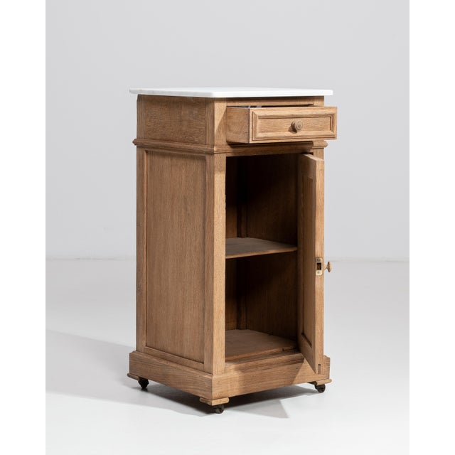 A refined example of French turn-of-the-century craftsmanship, this oak side table embodies the restrained elegance of the...