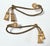 Elegant pair of vintage rope-style curtain tiebacks featuring twisted gilt cords finished with substantial decorative...