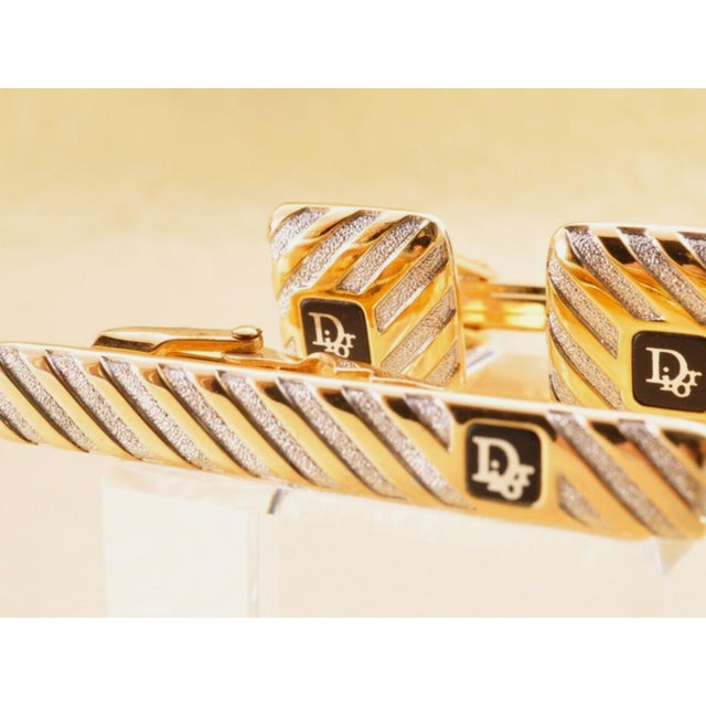 Vintage Christian Dior Gold Plate & Onyx Cufflinks Circa 1990 In Original Case Featuring a front Dior logo, a textured...