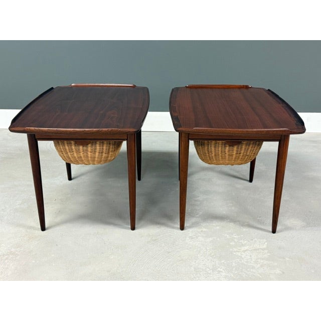 A pair of mid century modern teak side table designed by Poul Jensen for Selig with single pull out basket drawers....