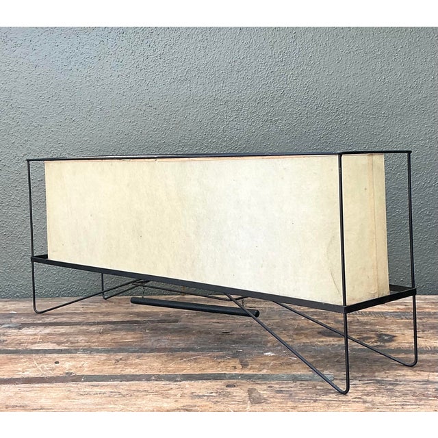 This striking Mid-Century Modern table lamp is a masterclass in minimalist geometry and diffused illumination. Featuring a...