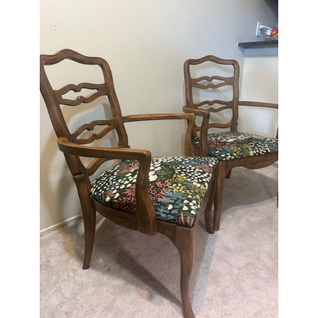 A pair of solid wood French A pair of solid wood French Provincial armchairs by Drexel Furniture Co., with the original...