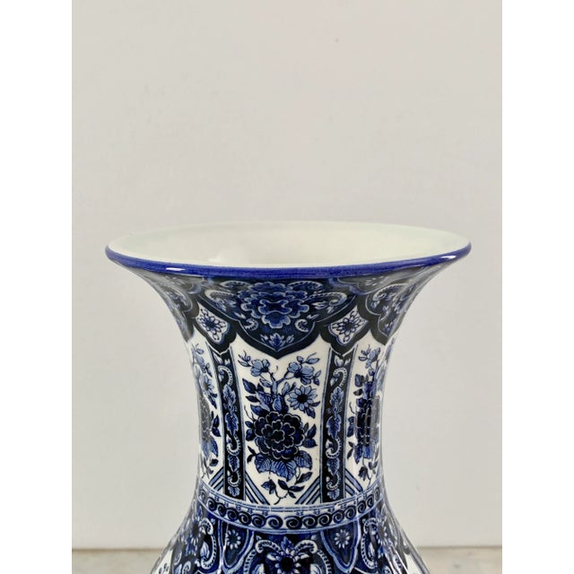 A richly decorated blue and white porcelain vase by Ardalt's Blue Delfia line, crafted in Italy during the mid-20th...
