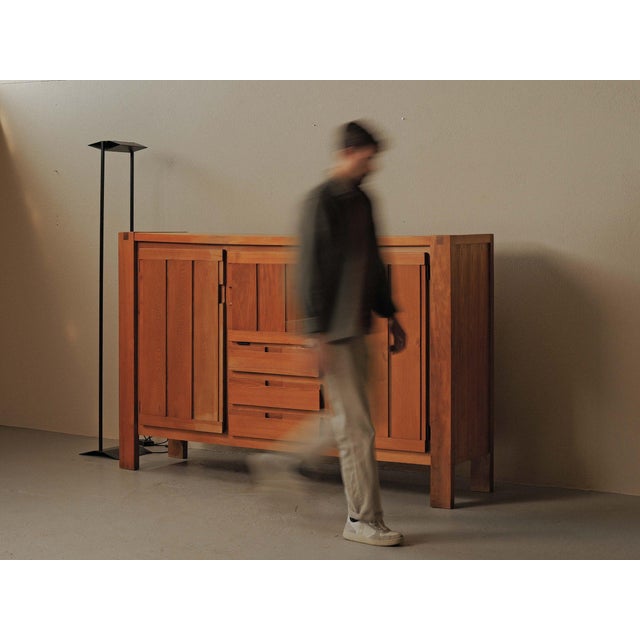 Substantial sideboard, produced by Monopoly in Limoges around 1980, crafted from solid elm and elm veneer. Its restrained...