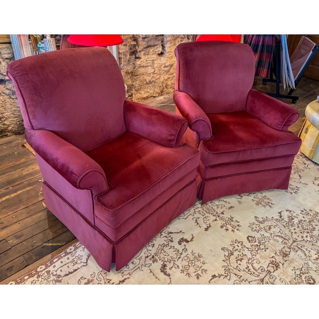Pair of Dark plum/burgundy club chairs. Comes with armrest cover. Labeled "Steel workers of America" with additional...