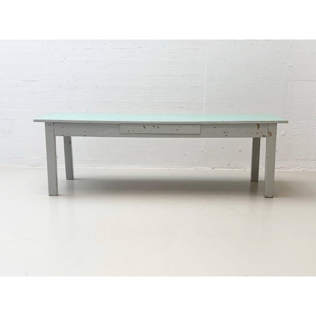 Authentic swiss-made workbench from the 1950s with a characteristic light green formica worktop and classic light gray...