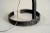 Floor lamp in blackened wrought iron signed "F.S", France 1960. The barrel is riveted to a circular flat iron base, a...