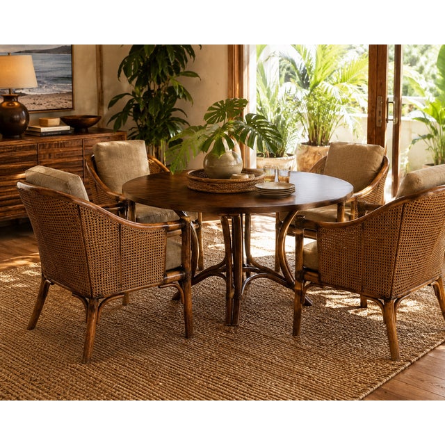 A sophisticated set of four vintage lounge dining armchairs by McGuire of San Francisco, blending the brand’s iconic...