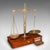 This is a fine set of antique apothecary weighing scales. An English, brass, mahogany and walnut countertop balance for...