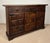 Attractive Spanish hardwood sideboard featuring a classic paneled door design and three upper drawers, enhanced with...