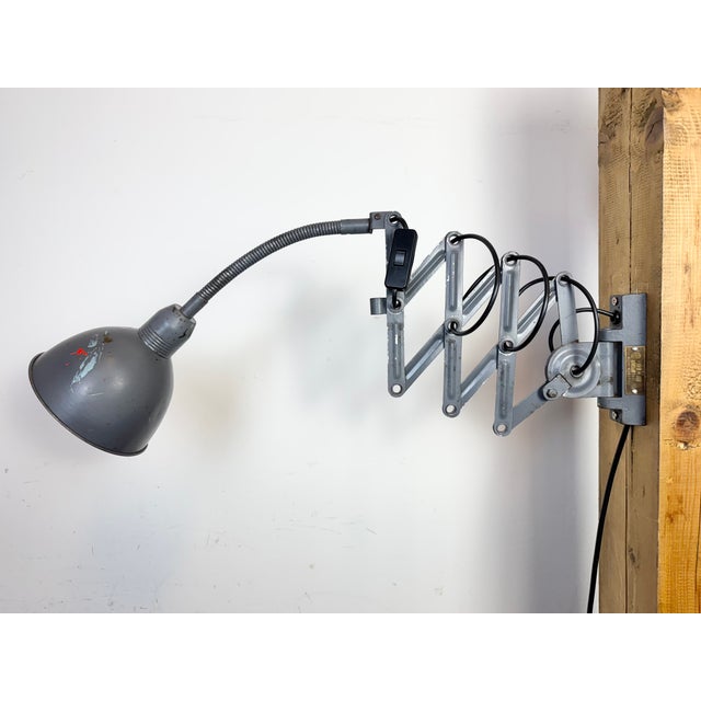 This vintage Industrial grey scissor wall light was produced by Elektroinstala Dečín in former Czechoslovakia during the...