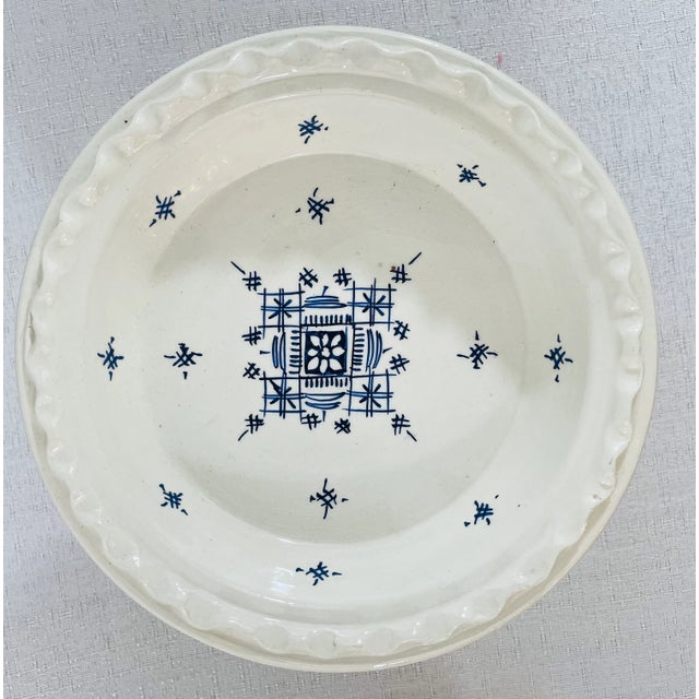 A pair of Moroccan handmade ceramic dessert plates with tribal berber motifs, one plate is decorated in blue and the other...