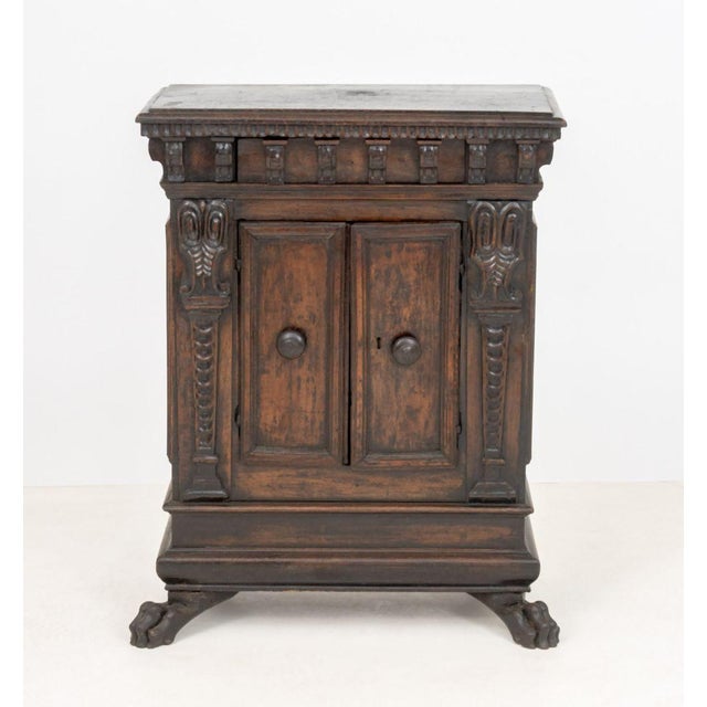 Italian Renaissance Walnut Cabinet, 17th century, two doors with locking mechanism flanked by carved columns on paw from...