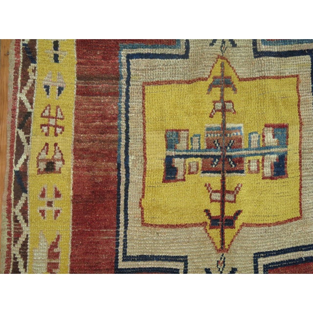 An eclectic Turkish Anatolian gallery size runner. Large medallions lie on a rusty brownish red field. 4'11'' x 11'8''