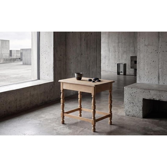 Side table in solid oak attributed to Danish designer Henning Kjærnulf. A decorative yet practical piece that can also be...