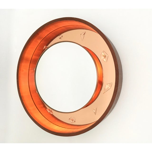 Made in Italy, 1950s-1960s. The external frame is made in teak. It is a beautiful back-illuminated wall mirror, which...